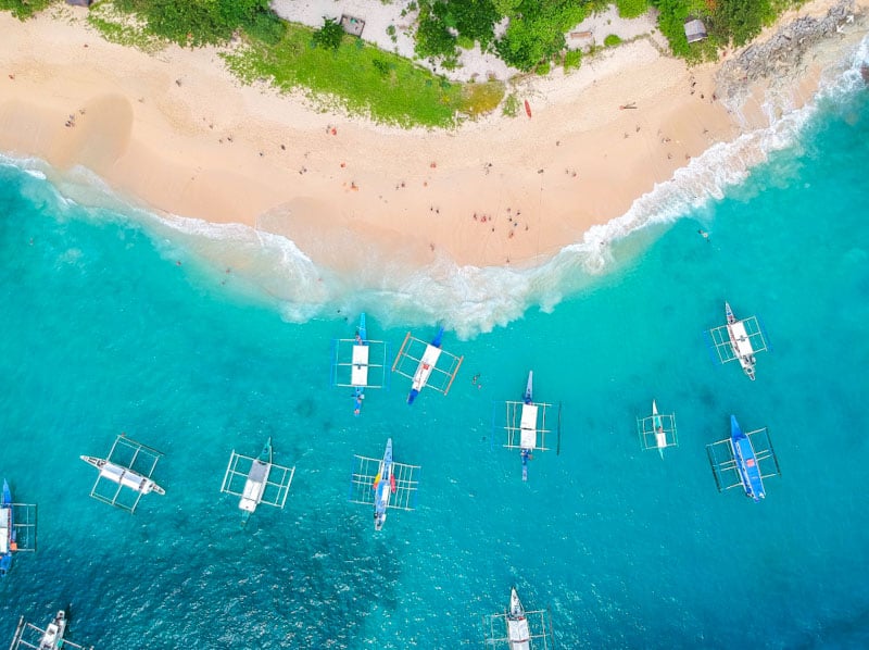 Snorkeling at Helicopter Island (Dilumacad Island) is a must in El Nido for its unique shape, clear waters, and vibrant marine life.