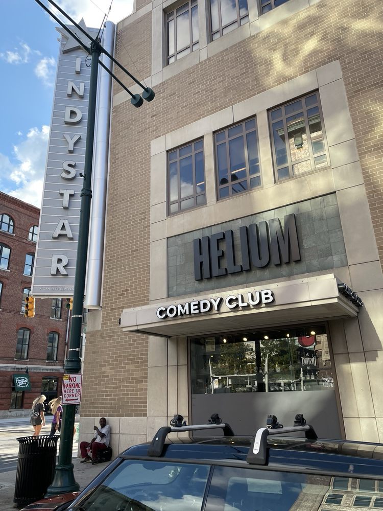 Exterior of Helium Comedy Club with large sign above the entrance in downtown Indianapolis.