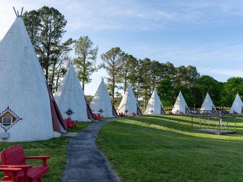 Historic Wigwam Village No. 2 offers 15 teepee-shaped rooms blending 1930s charm with modern comforts.