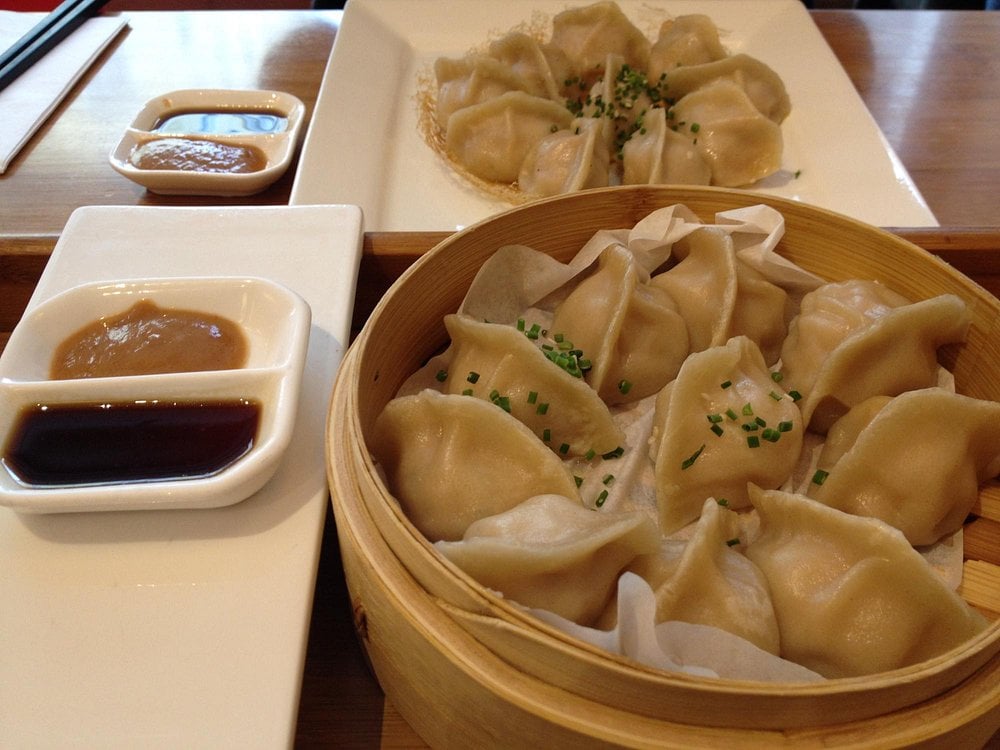 A serving of dumplings with dipping sauces at LeDu Happy Dumplings.