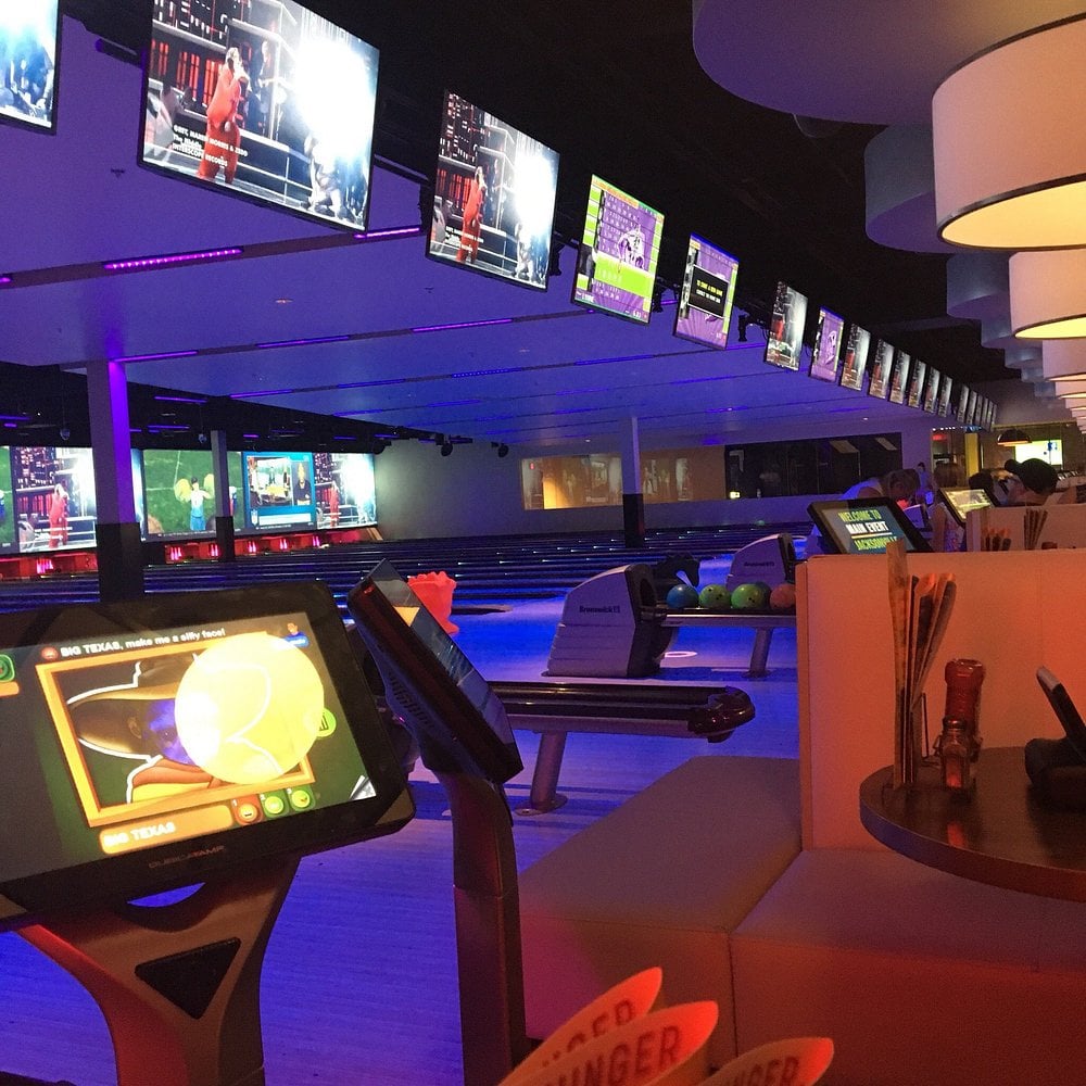 Arcade games and seating area inside Main Event entertainment center.