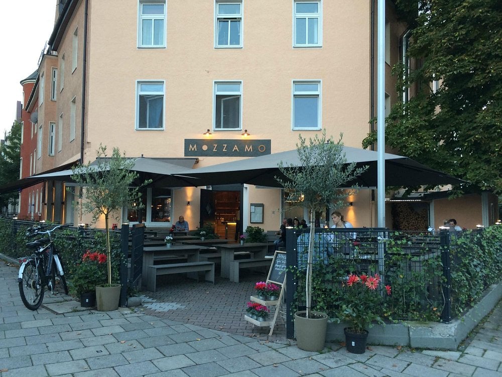 Outdoor seating at Mozzamo with modern decor and a cozy vibe.