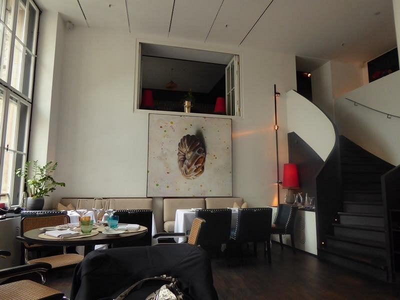 Elegant and artistic interior of Pageou restaurant with modern seating.