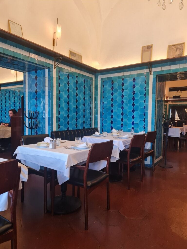 Classic interior of Pandeli with blue tiled walls and white tablecloths.
