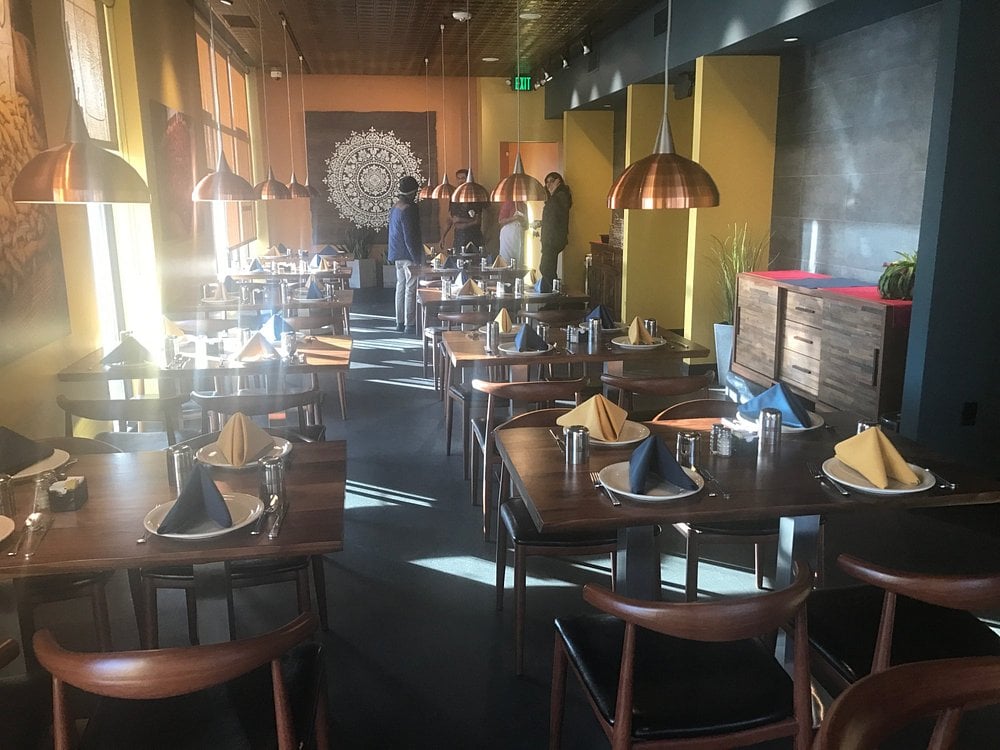 Vibrant Indian restaurant with colorful walls and copper lighting at Saffron Valley.