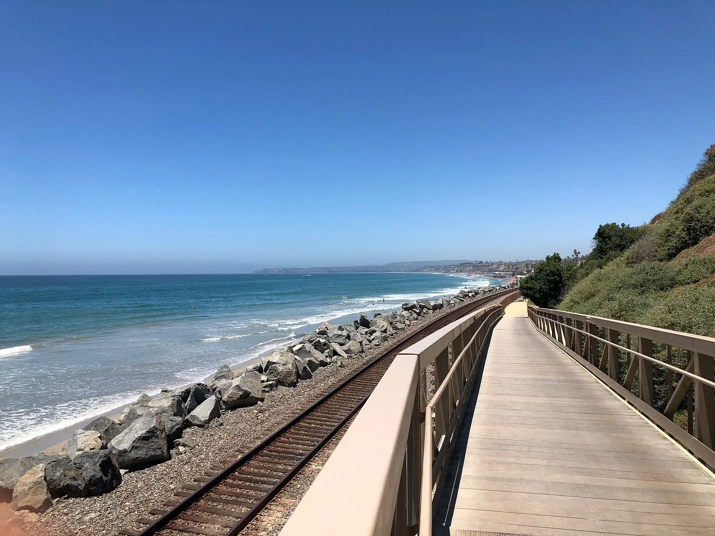 San Clemente Beach Trail elevated boardwalk overlooking Pacific Ocean and railroad tracks, one of the hidden gems in Orange County for coastal hiking.
