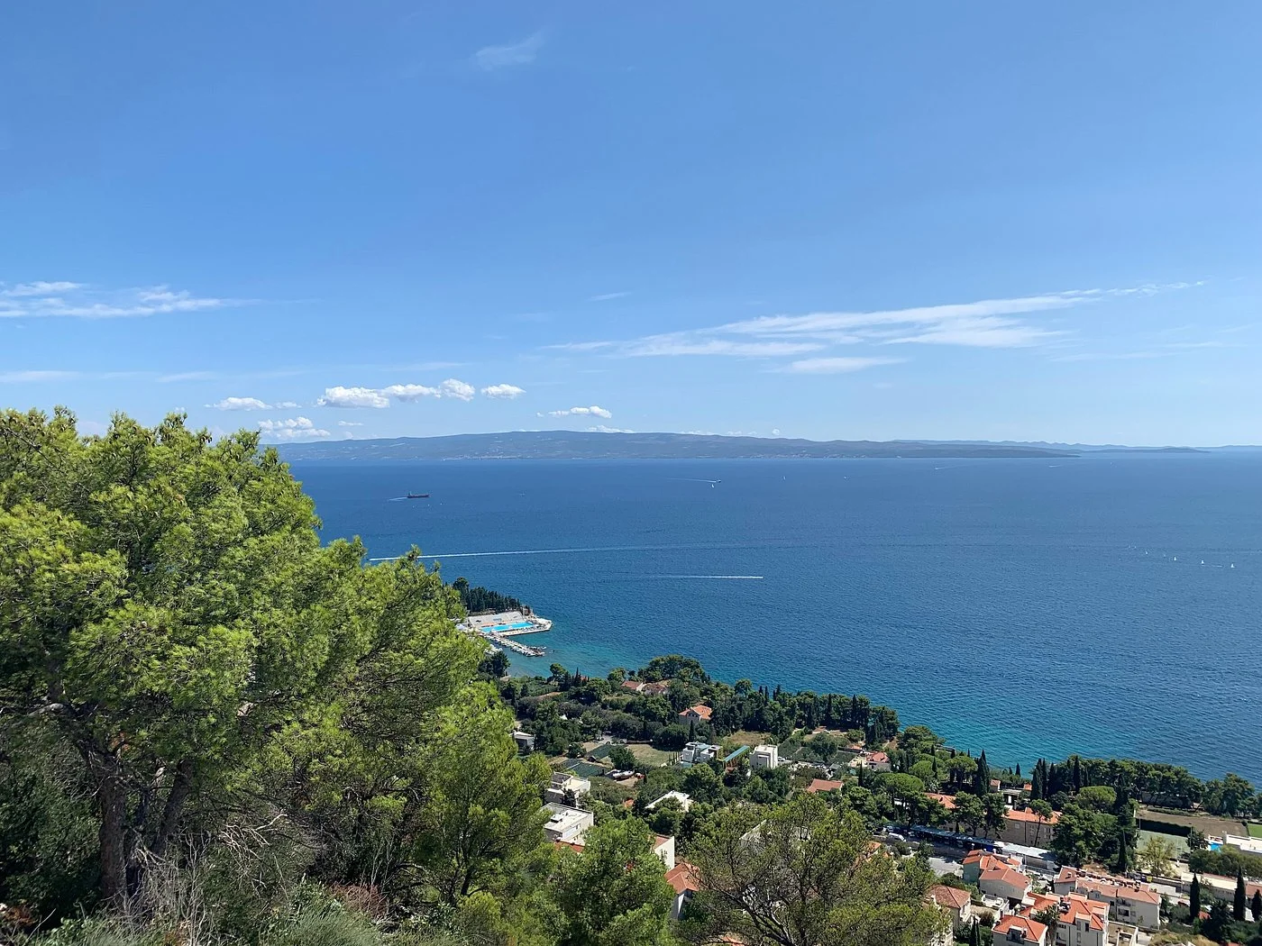 Sustipan Peninsula, one of the most beautiful places in Split, offers panoramic Adriatic views with turquoise waters, red-roofed houses, and lush Mediterranean coastline