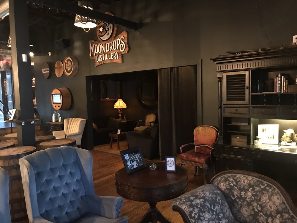 Cozy interior of The Vault Indy at Moondrops Distillery with vintage furniture and warm lighting.