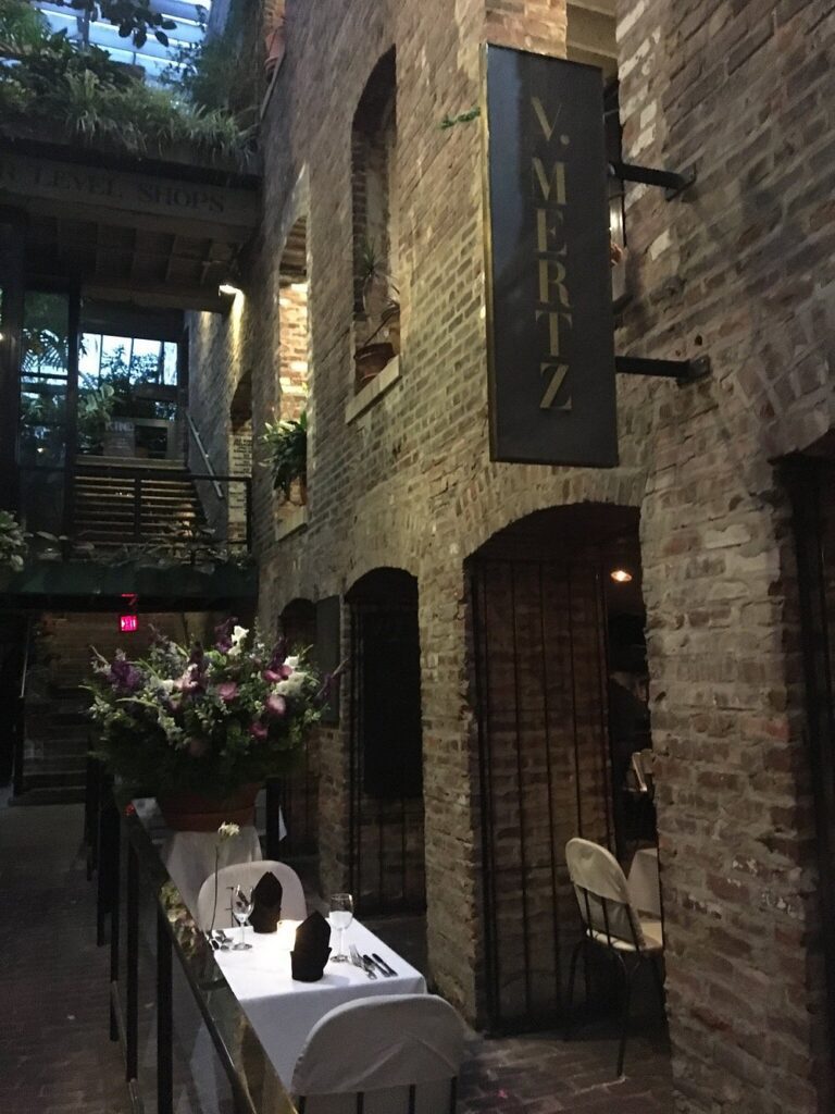 Romantic brick-walled dining area outside the entrance to V. Mertz.