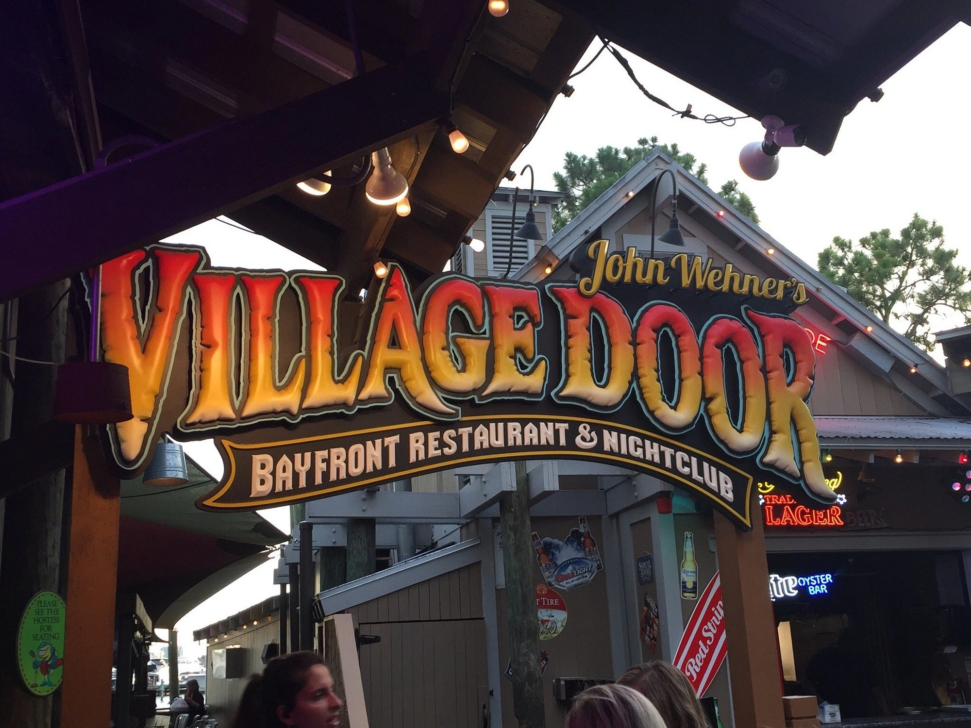 Village Door Baytowne Restaurant and Nightclub sign at Destin Florida entertainment venue.
