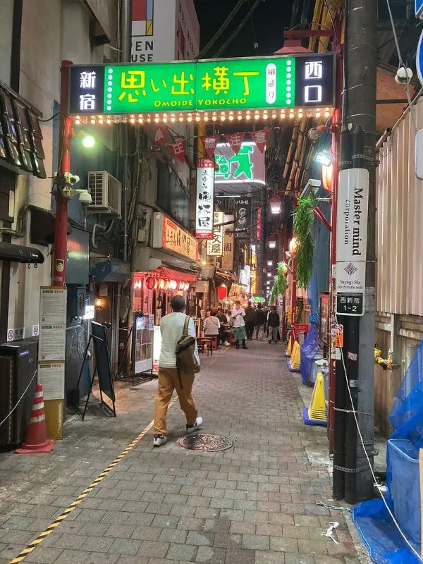Entrance to Omoide Yokocho alley in Shinjuku lit up at night.