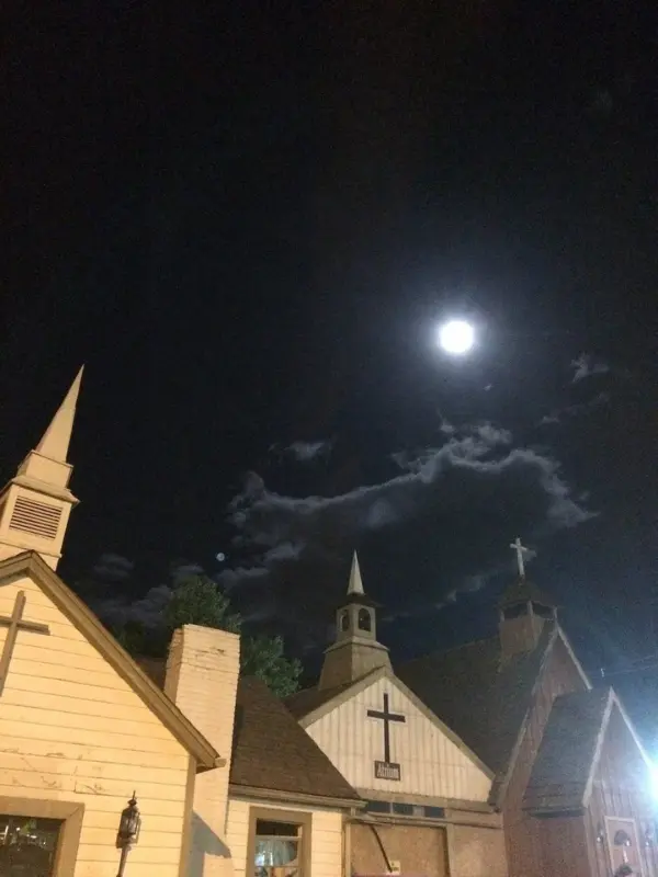 Ghost & Haunt Tours shows old chapel buildings lit by the moon at night.