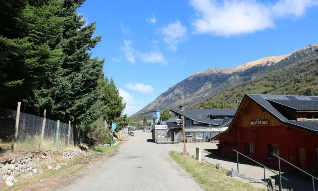 A quiet road leads toward the mountains through a village in Bariloche.