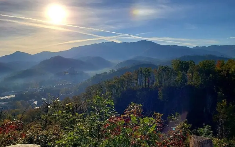 Maryville mountain view at sunrise with trees in the foreground.