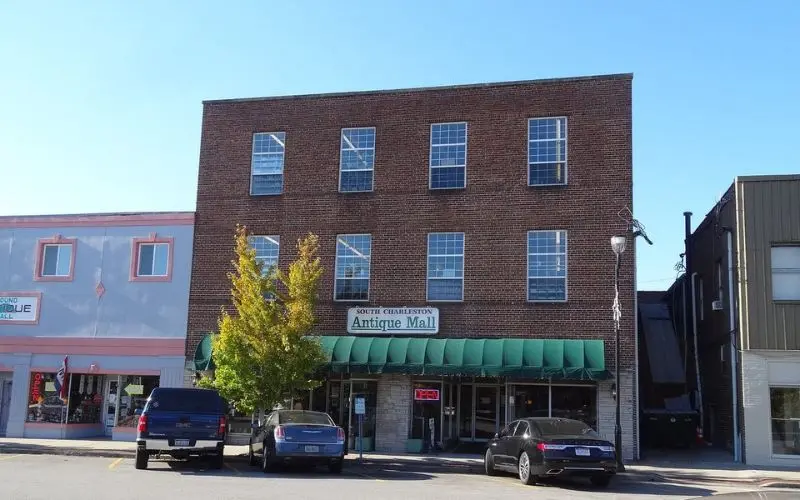 The South Charleston Antique Mall has a brick exterior and green awning.