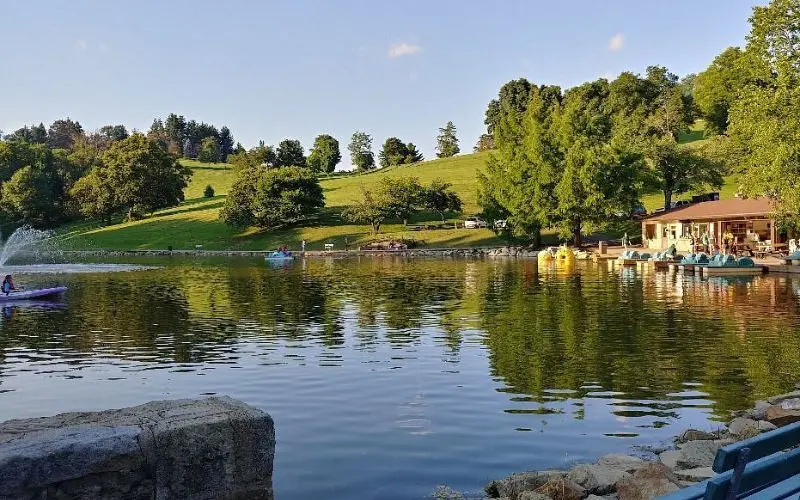 People enjoy paddle boats and water activities at Wheeling Park lake.