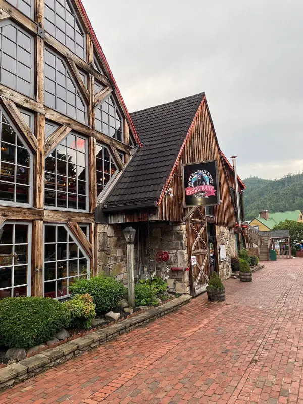 Smoky Mountain Brewery has a rustic timber-and-stone exterior with a brick walkway.