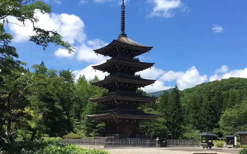 Five-story wooden pagoda surrounded by greenery in Sendai.