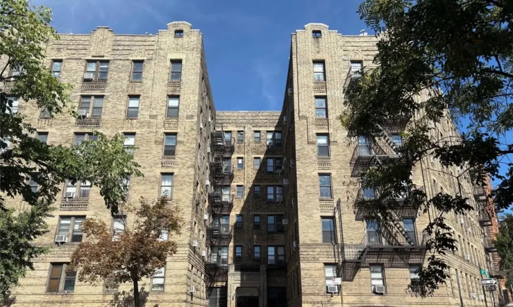 A large brick apartment building with fire escapes in Sunnyside.
