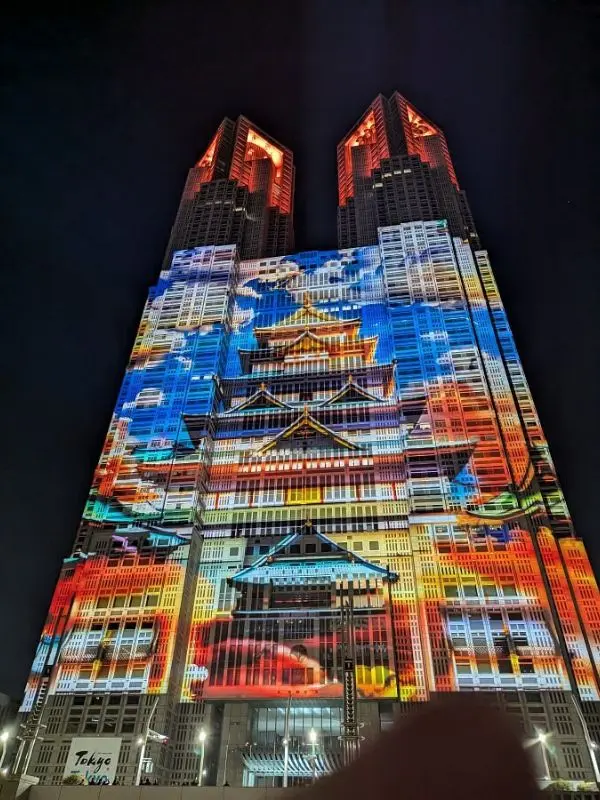Tokyo Metropolitan Government Building lit up with colorful projection mapping.