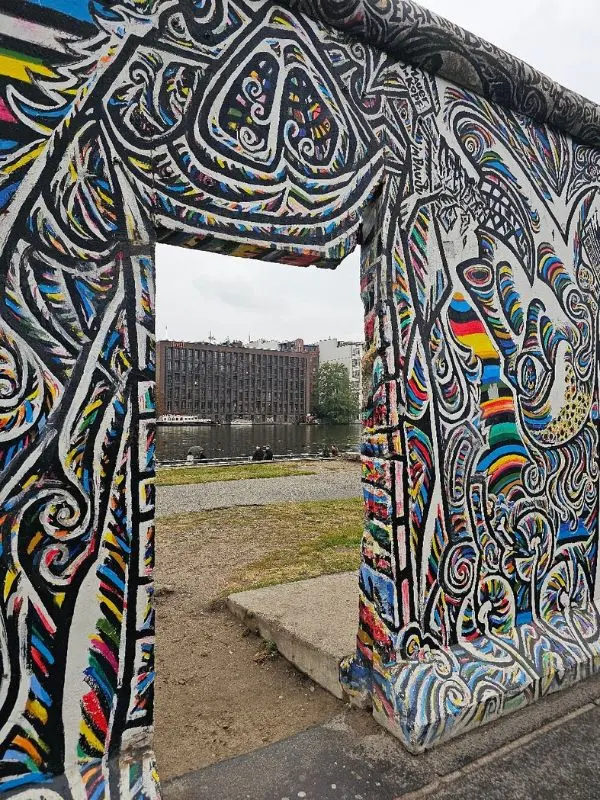 A colorful mural decorates the Berlin Wall at the East Side Gallery.
