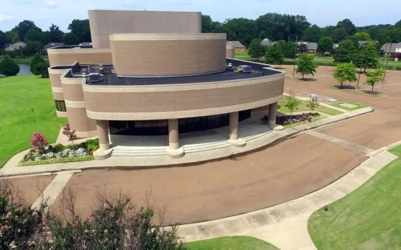 Modern circular building surrounded by green space in Bartlett.