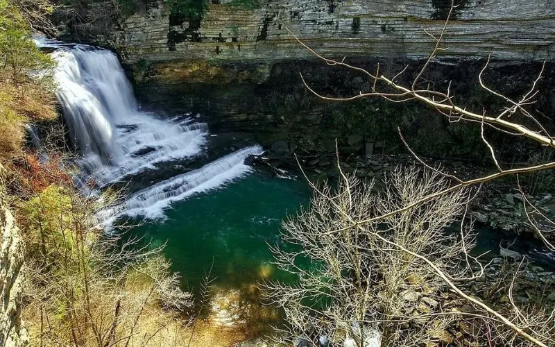 Waterfall cascading into a clear pool surrounded by rocks in Cookeville.