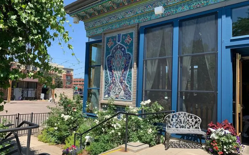 The Boulder Dushanbe Teahouse shows colorful tilework and flowers outside.