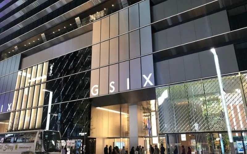 The modern exterior of Ginza Six shopping mall at night.