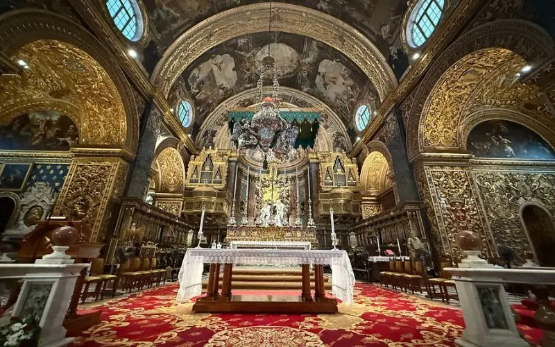 Ornate golden interior and altar of St. John’s Co-Cathedral.