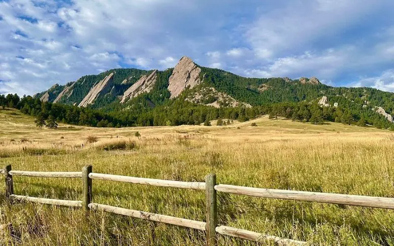 Chautauqua Park has grassy fields with the Flatirons in the background.