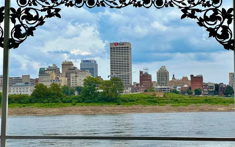 Skyline of Germantown across the river framed by decorative railing.