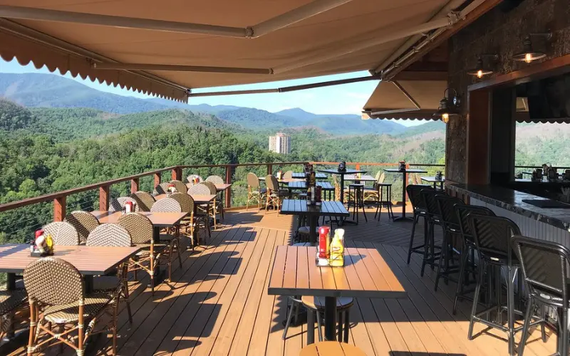 Cliff Top Grill & Bar offers outdoor dining with mountain views from a wooden deck.