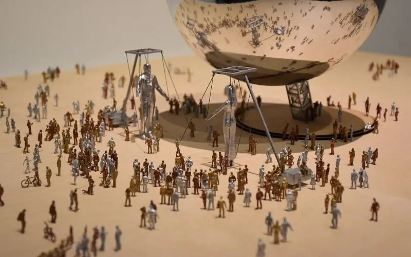 An art installation with miniature figures at Mori Art Museum.