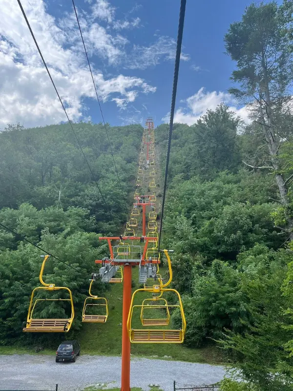 Gatlinburg SkyLift Park features bright yellow chairlifts carrying visitors up the mountain.