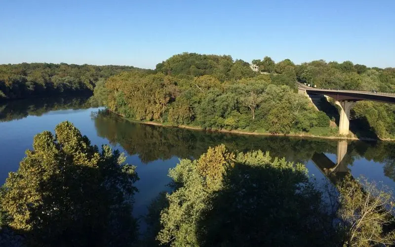 A bridge spans the river with tree-lined banks in Shepherdstown.