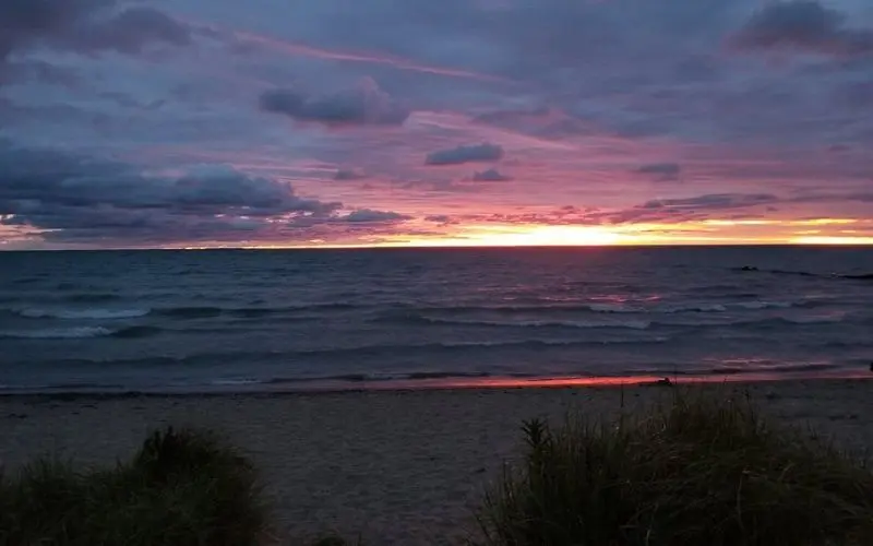 Colorful sunset over Lake Michigan waves in Shorewood.