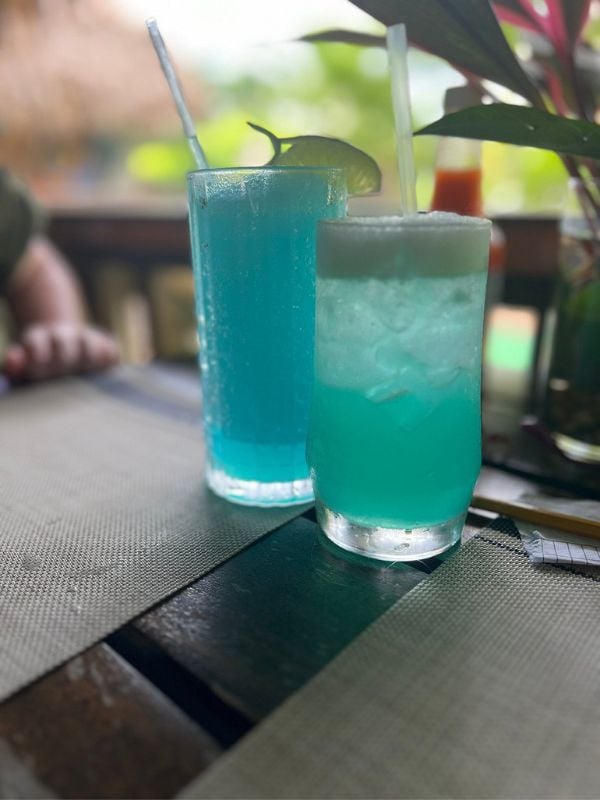 Enjoying a drink on the beach is a top free activity in Placencia, providing a connection to Belize's natural beauty.