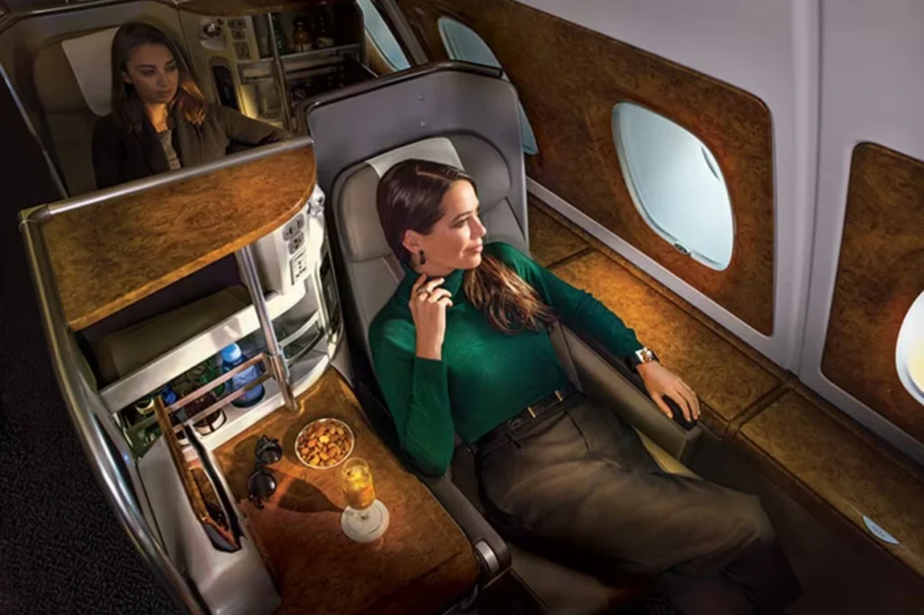 Lie flat business class seat on Emirates with personal minibar and entertainment