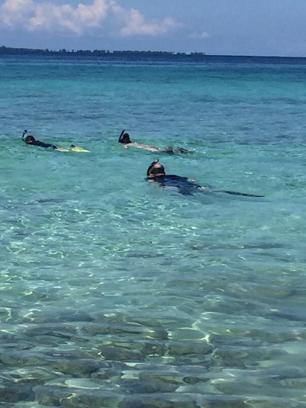 Placencia's waters, a snorkeler's paradise, unveil Belize's vibrant marine diversity.
