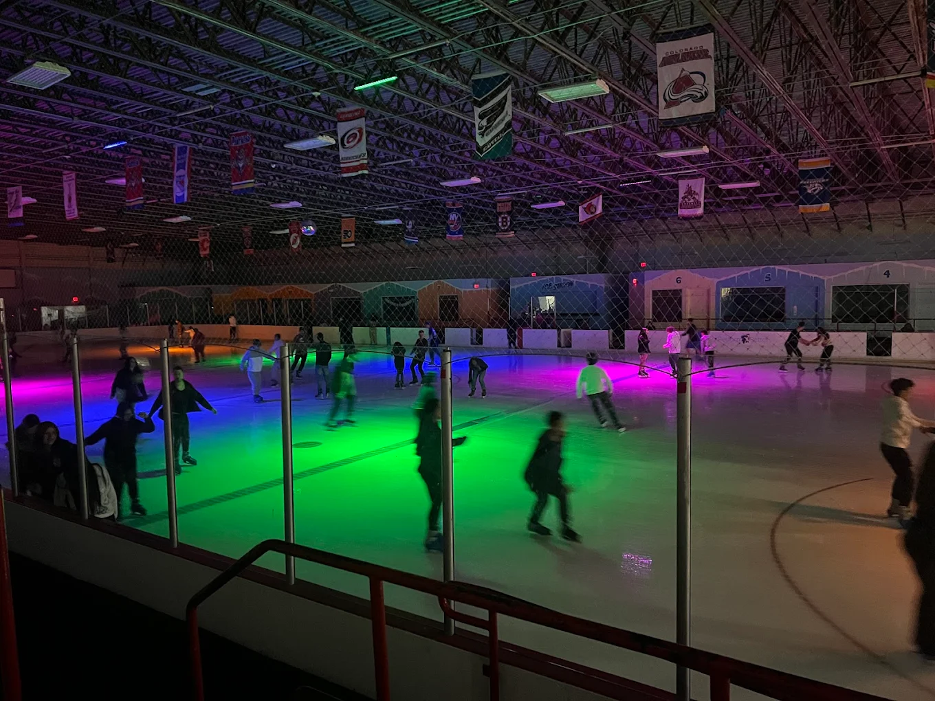 Ice skaters enjoying disco night with colorful lighting at Kendall Ice Arena, a unique activity among the best things to do in Miami for young adults