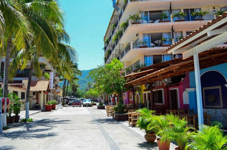 Colorful street scene in Zona Romántica Puerto Vallarta with outdoor cafe and palm trees