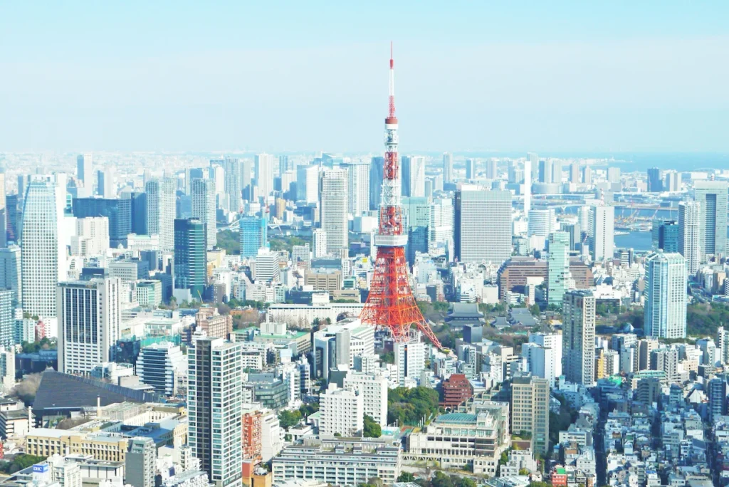 The red and white Tokyo Tower rising high above the dense cityscape of Tokyo