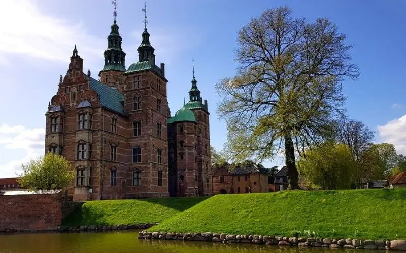 Rosenborg Castle in Copenhagen, Denmark with moat and gardens.