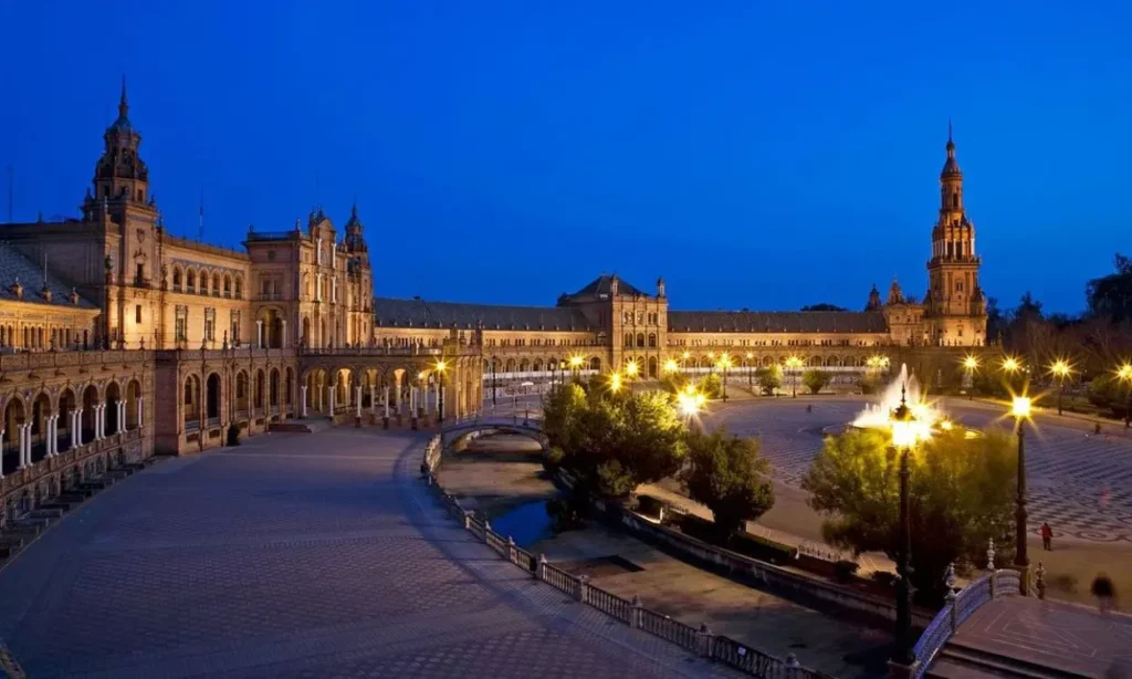 Plaza de España in Seville, Spain beautifully lit up at dusk.