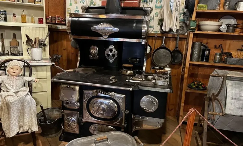 A vintage stove and old kitchen items on display inside the Museum of North Idaho.