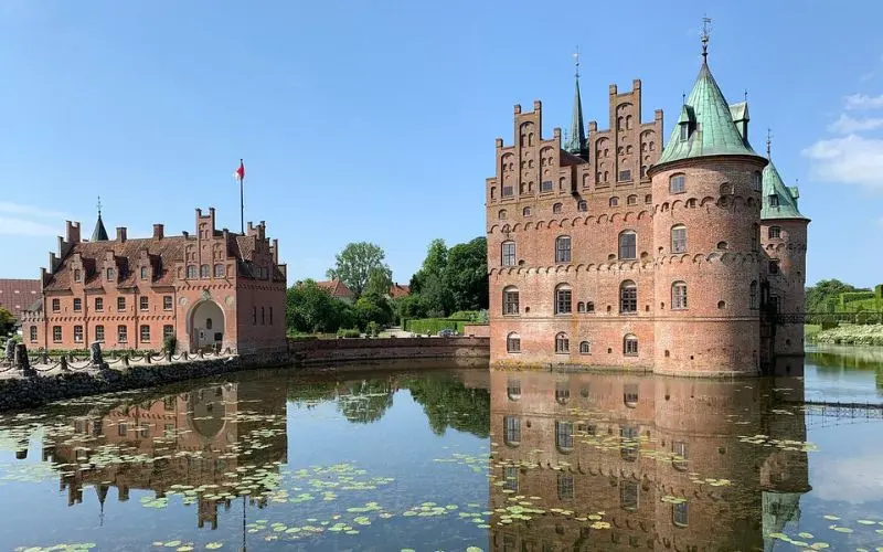 Egeskov Castle in Odense, Denmark reflected in the lake.
