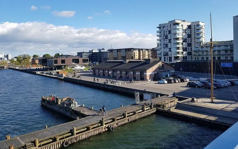 Aalborg waterfront in Denmark with docks and modern buildings.