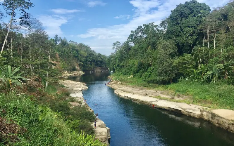 Ecuador features a river running between rocky banks and forest.