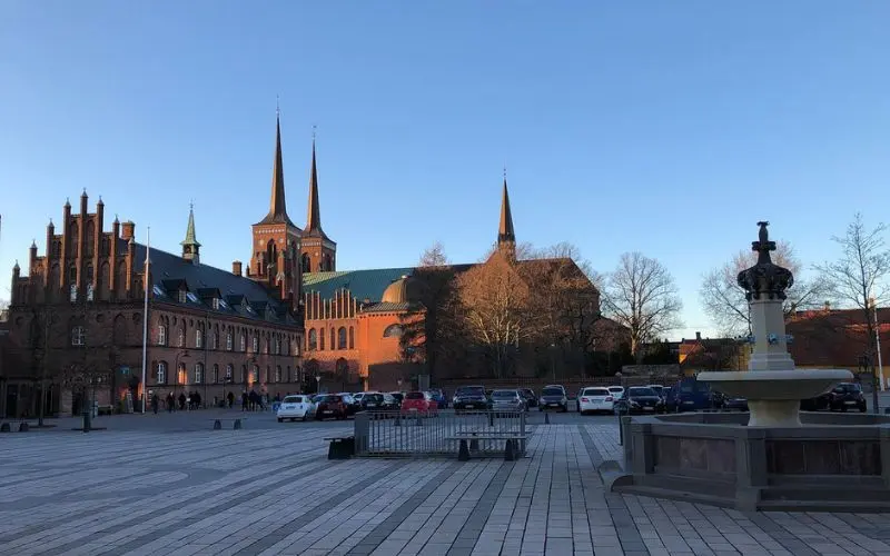 Roskilde Cathedral in Denmark with tall spires and red brick.